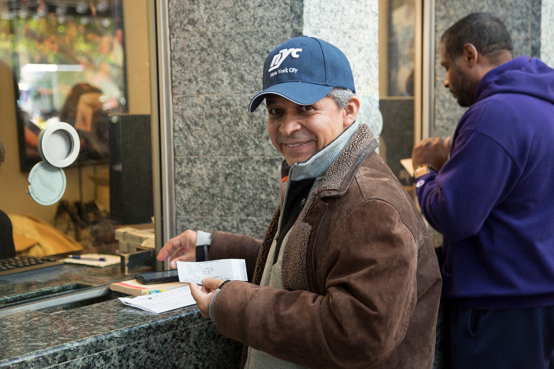 male getting tickets at Straz Center's ticket window.